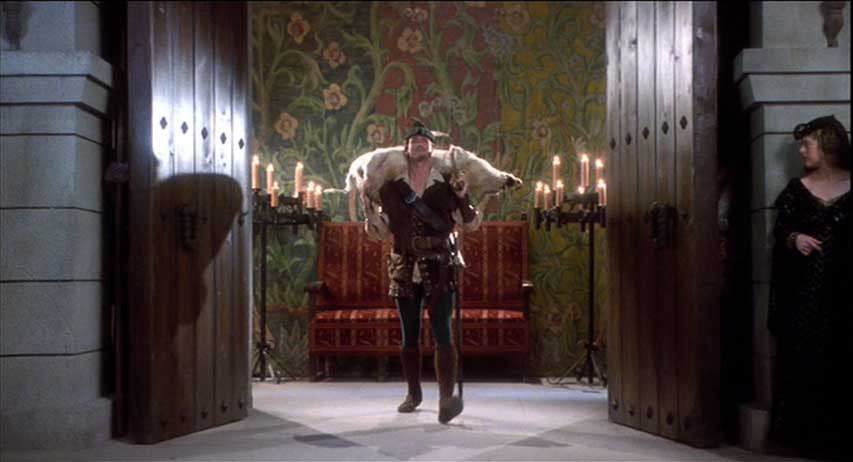 Cary Elwes as Robin Hood with a pig on his shoulders