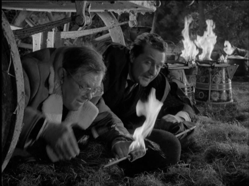 Carlyon tries to extinguish Steed's flaming bowler hat