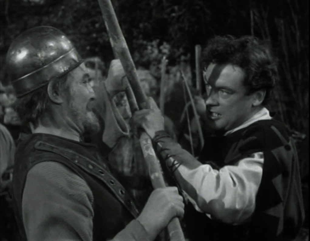 Close-up of Will and Robin with crossed quarterstaffs